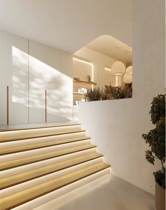 Entrada da clínica com escadas de madeira iluminadas por LEDs, que conduzem à receção de design moderno.