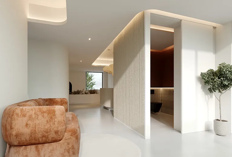 Corredor e sala de espera da clínica, destacando um sofá de design curvo em veludo e a arquitetura de interiores moderna.